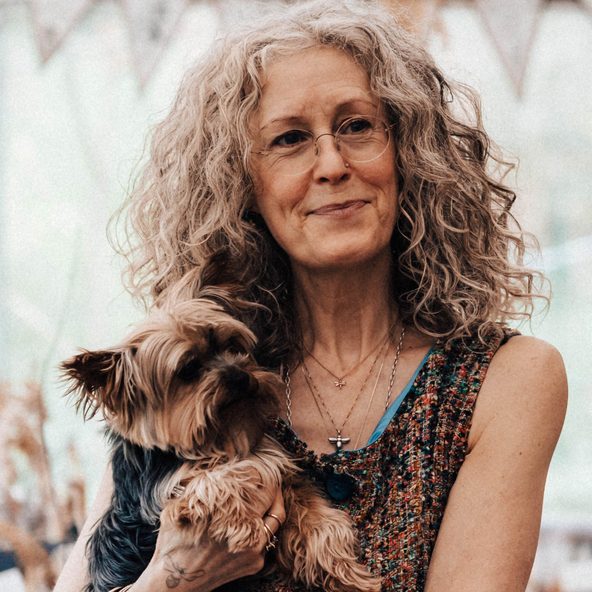 A photograph of Be Montague holding her dog, a Yorkshire Terrier named Fizzy